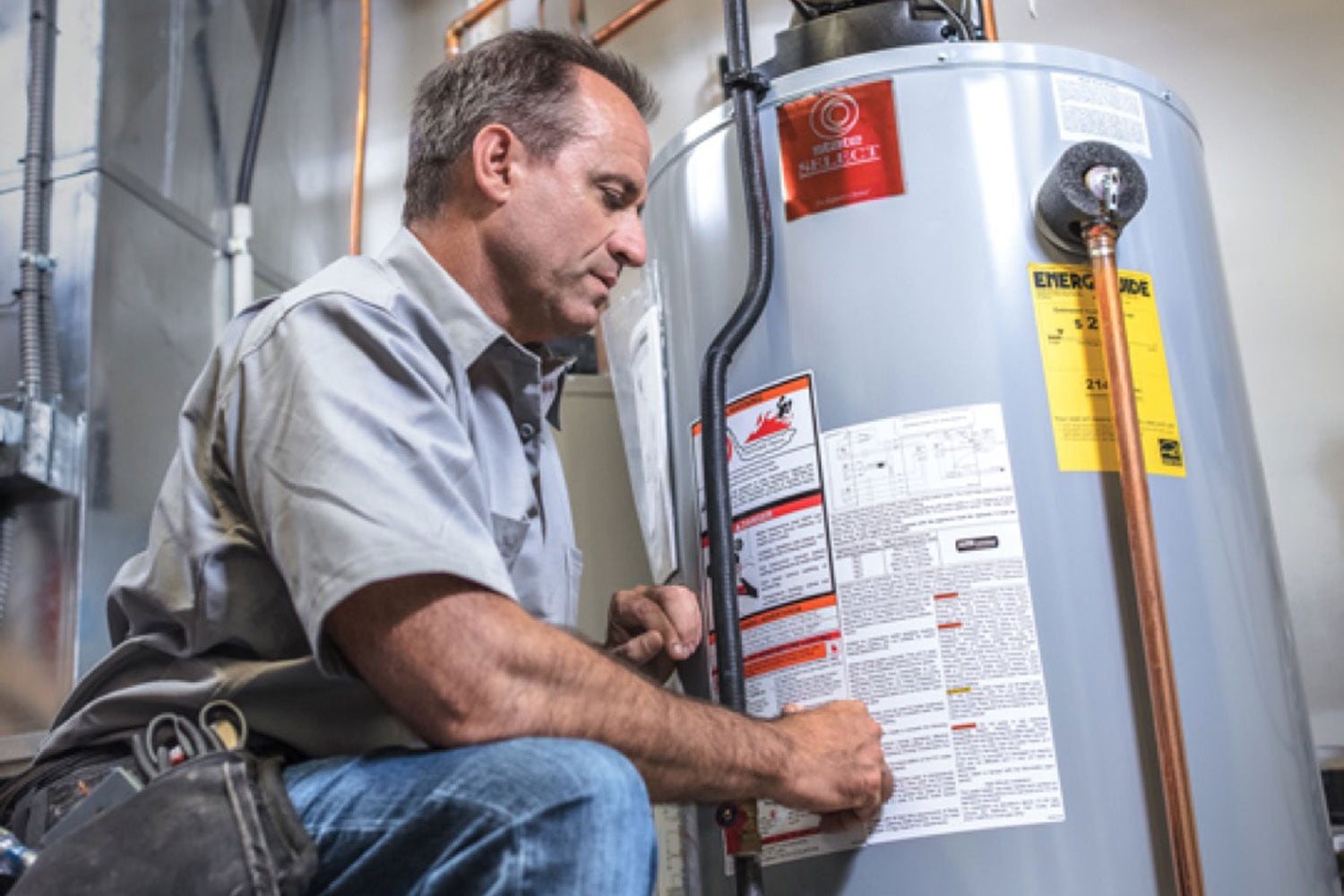 A Superior Propane residential partner inspects a water heater. 