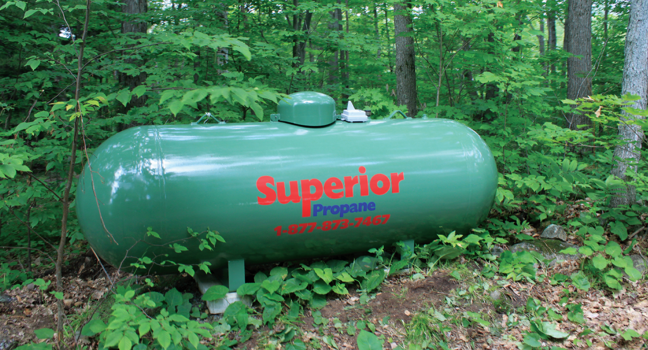 Green Superior Propane Tank in a Forested Area
