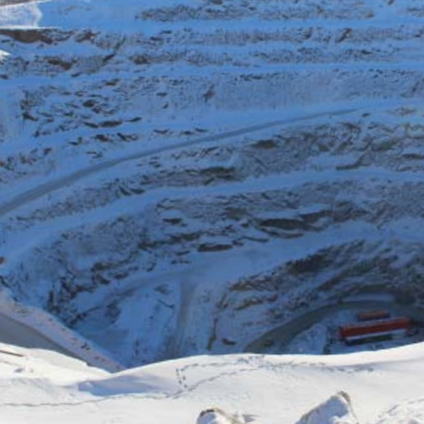 Excavator Loading a Dump Truck At a Capstone Mine