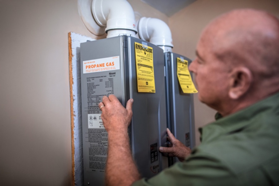 Superior Propane employee servicing a tankless water heater. 