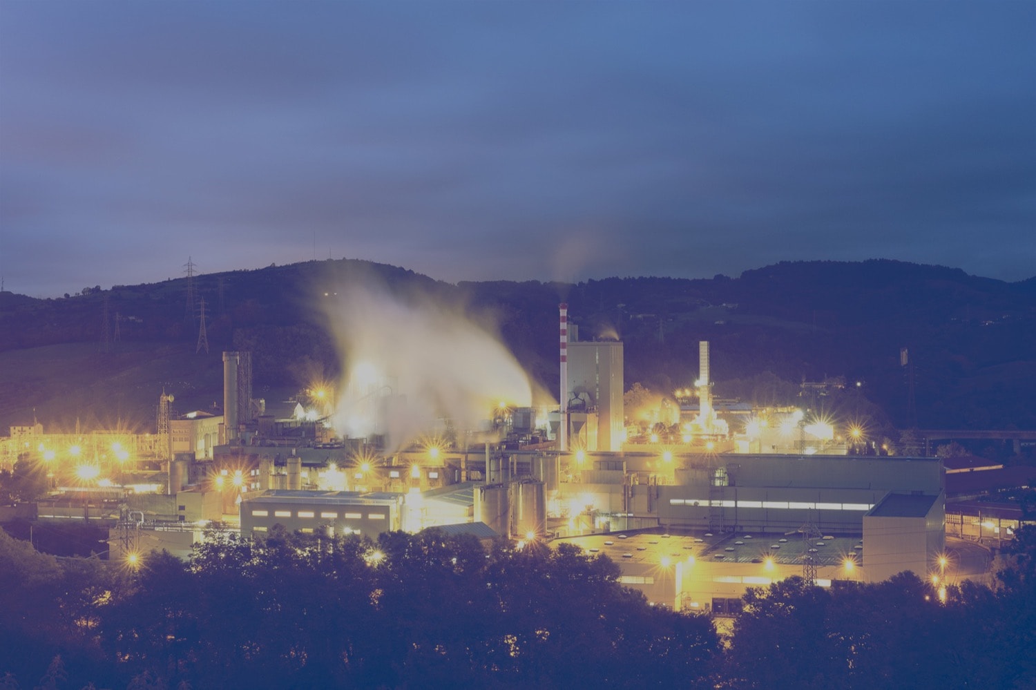 Panoramic view of an oil refinery at night.
