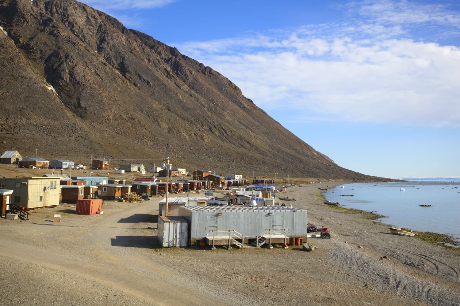 Small town next to the mountains and lake in Nunavut. 