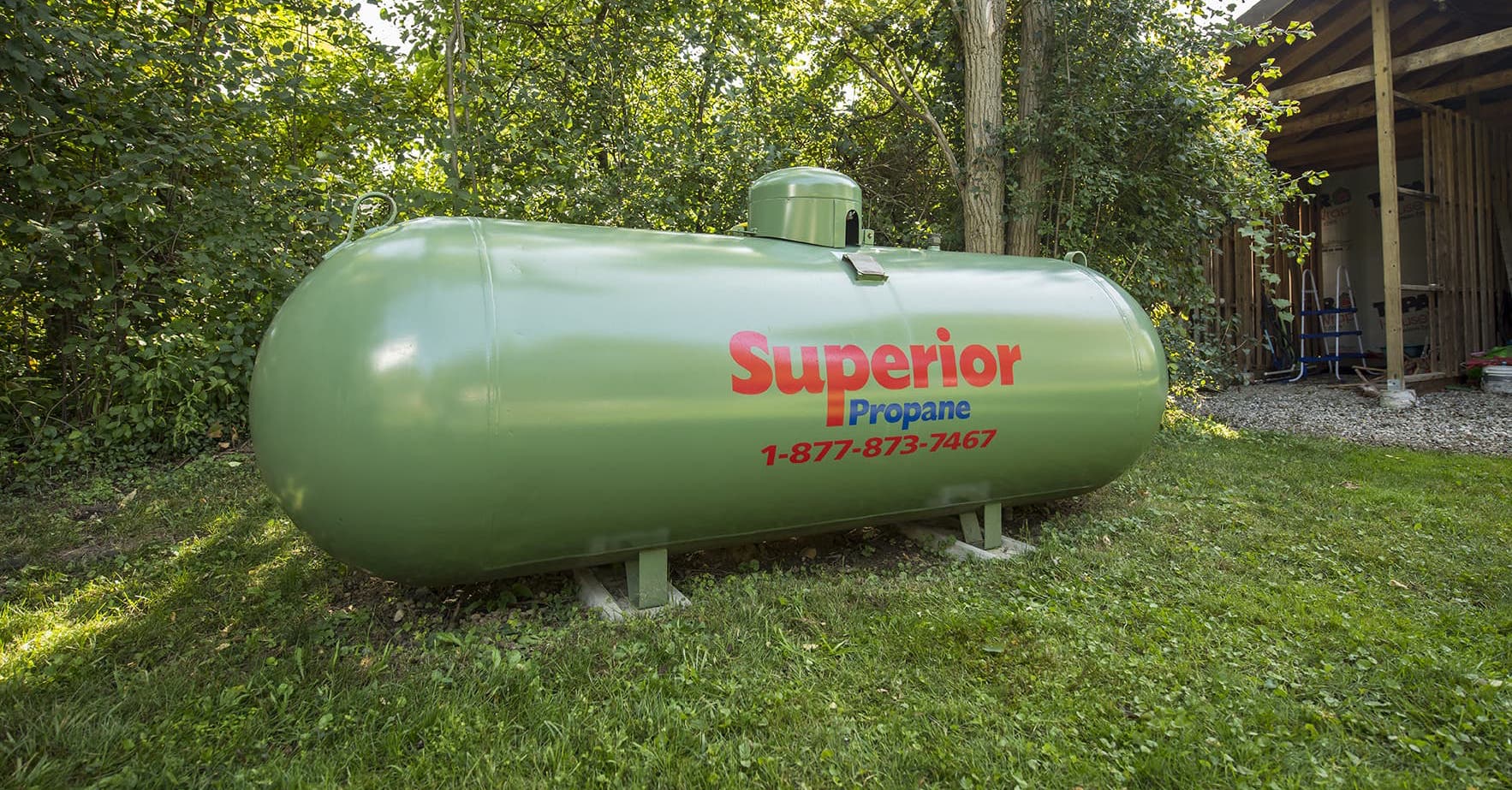 Superior Propane tank next to a shed in a residential backyard. 